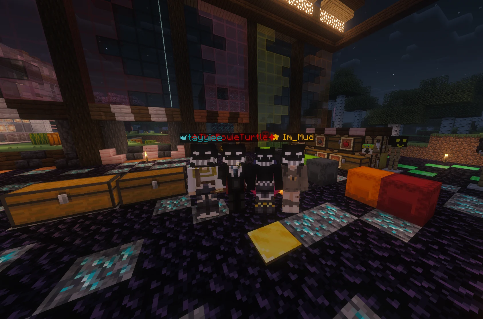 Four friends in matching skull helmets inside a community base