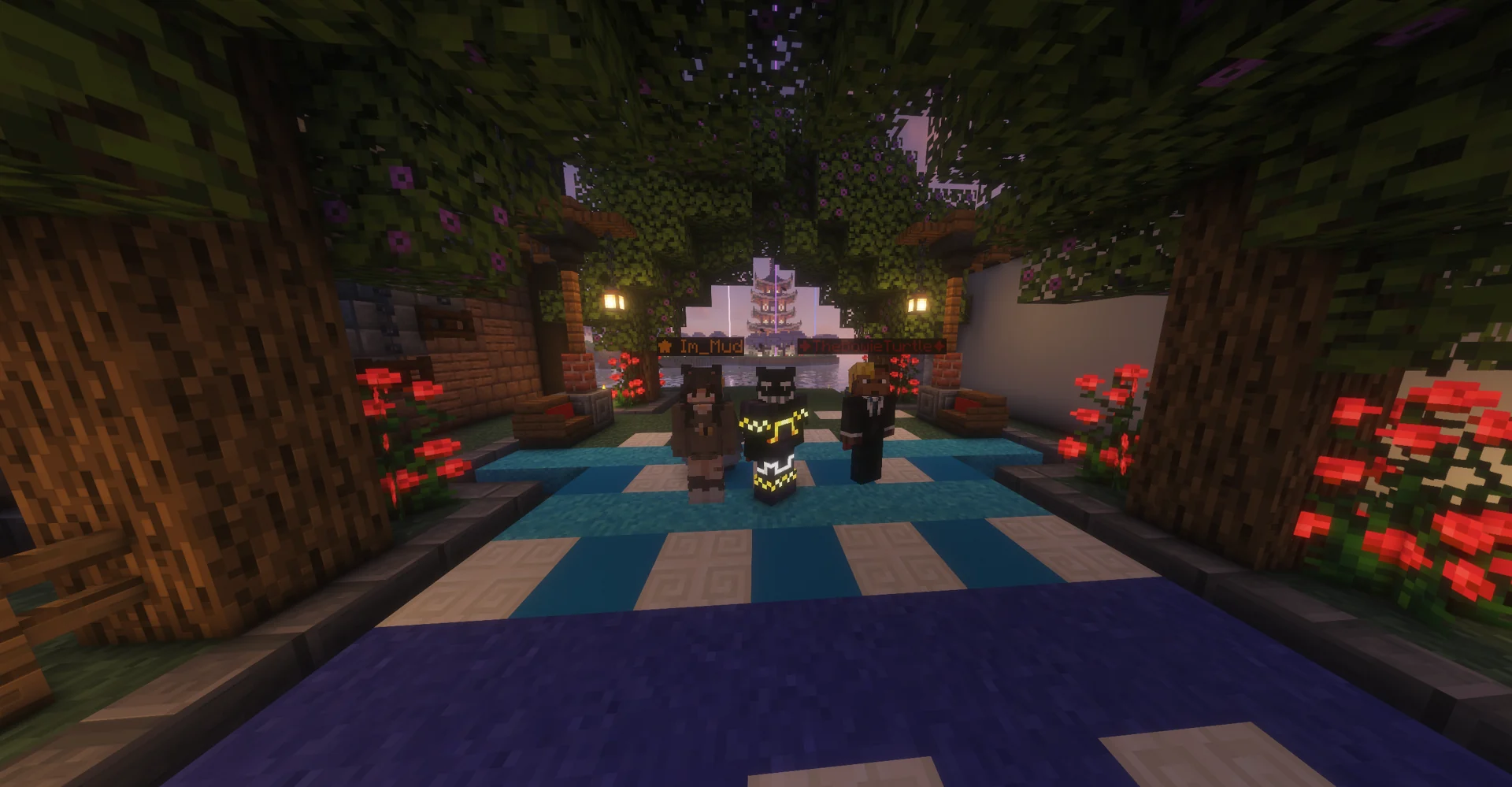 Three PureMC friends beneath a leafy garden arch